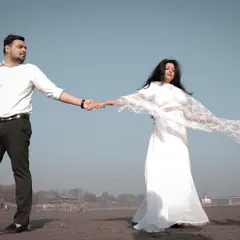Capturing a candid moment of love and connection during a pre-wedding shoot on the sandy banks of the Yamuna.