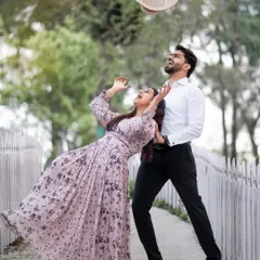 Let's have fun with it. A pre-wedding shoot should be full of laughter and playful energy. This spontaneous moment, with Arihant tossing his hat as Ishu laughs, perfectly captures the lighthearted and joyful side of their relationship.