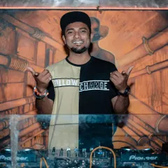 Behind the decks with a smile, ready to get the party started. My attitude is all about bringing good vibes and making sure everyone has an impeccable night.