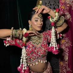 This shot captures the beauty of traditional floral jewelry, known as 'gajra', paired with a modern, high-fashion makeup look.