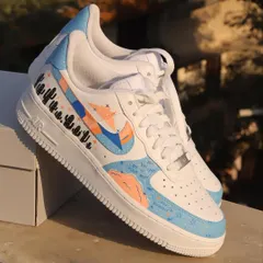 This freehand design on a pair of Nike Air Force 1s features a dreamy, abstract aesthetic with a pastel color palette, cloud-like shapes, and a row of cute cacti.
