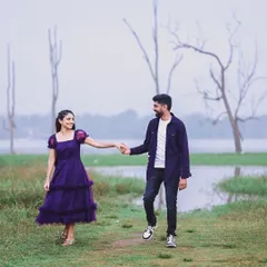 This shot captures a sweet, candid moment between the couple. Her purple dress adds a pop of color to the serene, natural landscape of their pre-wedding shoot.