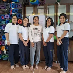 A group of students after a class. The community we build is just as important as the yoga we practice, offering encouragement and a shared sense of purpose.