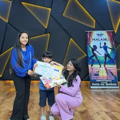 Celebrating achievement is a core part of our camp. Here, a young boy proudly receives his certificate and prizes from our instructors, his face beaming with a sense of accomplishment.