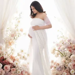 Surrounded by a sea of delicate flowers, this portrait embodies a bright and dreamy aesthetic. We use soft, high-key lighting to create an ethereal glow, making you the serene center of a floral wonderland.