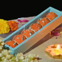 A closer look at the Motichoor Laddoo candles from my Mithai collection. Each one is detailed with silver 'vark' made of wax, arranged neatly in a slim box, making for a unique and tempting festive favor.