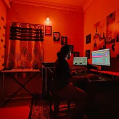The studio environment is crucial for creativity. The orange lighting helps me get into a focused zone for producing warm, energetic house music.