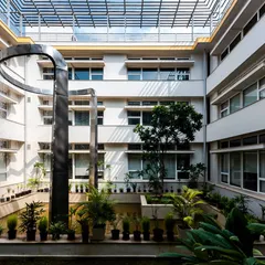 The central courtyard of our LEED Platinum certified office in Noida. The space is designed around a water body that acts as a natural heat sink, passively cooling the building and creating a tranquil heart for the workplace. This is how we build spaces that breathe.