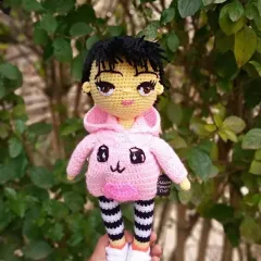 A close-up of the finished custom doll, showing the detailed crochet work on her face, hair, and clothing.