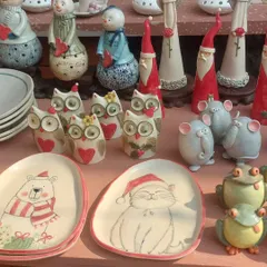 A close-up of my market stall, showcasing my Christmas collection. You can see the hand-painted details on the festive cat and bear plates.