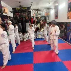 A full class practicing their fundamental stances. A strong stance is the base for every block, punch, and kick. We drill this relentlessly.