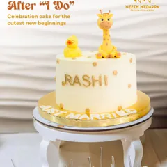 Cute beginnings after 'I do'. This whimsical 'Just Married' cake was designed for a sweet and playful celebration, featuring adorable, handcrafted giraffe and duck toppers and personalized with the bride's name.