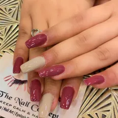 A sophisticated color-block design on square nails. This set features a mix of deep mauve and nude-colored nails for a modern and chic look.