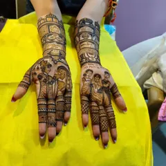 A tribute to family. This custom mehandi includes portraits of the bride's parents on one hand, with the message "My Mom is My Hero," and the couple on the other.