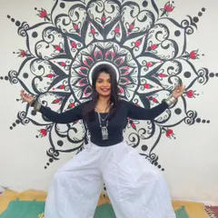 Here I am in Goddess Pose, a powerful stance that grounds your energy, in front of a mural I painted. For me, art and yoga are both forms of expression and meditation that help me feel centered and strong in my body.