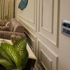 A close-up of the wainscoting detail on the walls. This classic design element adds a layer of architectural interest and sophistication to any room, and we often use it to create an elegant backdrop.