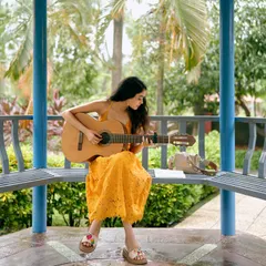 Finding a quiet spot in a park with my guitar is my happy place. This is where I often sit to brainstorm lyrics and melodies, inspired by the stories people share with me for their unique songs.