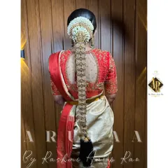 The back of a bridal blouse deserves just as much attention. This design features a sheer net panel framed by intricate embroidery, perfectly complementing the bride's traditional hairstyle and accessories.