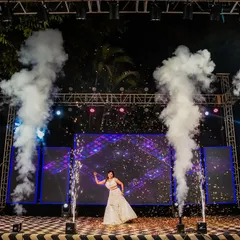 A spectacular solo dance performance by the bride on a grand stage with pyrotechnics and a dynamic LED backdrop.