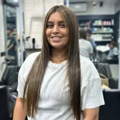 A frontal view showcasing the sleek, straight finish of the hair treatment. Her hair now frames her face perfectly, and the highlights add depth without compromising the smooth texture.