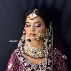 A close-up of a stunning bride in a deep purple ensemble. I focused on a dramatic smokey eye and a perfectly blended base to complement her magnificent Polki and ruby jewelry.