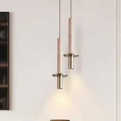 A pair of elegant pendant lights combining natural stone with brass fittings. This design is perfect for adding a touch of understated luxury to a modern space.