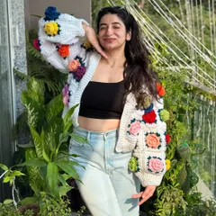 This chunky white cardigan adorned with 3D floral granny squares is a true statement piece. It’s one of our most intricate designs, combining a cozy fit with a garden of colorful, handcrafted flowers.