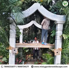 Our craftsmen at work, making final adjustments to the stone arch structure to ensure a perfect fit and a flawless finish.