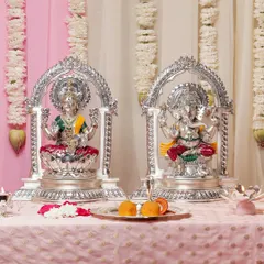 Bring home the combined blessings of wisdom and wealth with this grand silver-plated Lakshmi and Ganesha set. Each idol is seated within an ornate silver arch, creating a harmonious and powerful presence for your home temple.