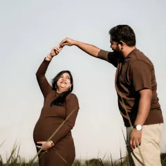 A joyful, backlit portrait of the couple sharing a dance in a field at sunset. The golden light creates a beautiful halo effect, adding to the magic of the moment.