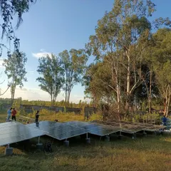 Our team at work setting up the solar array for the Echoes of Earth festival. This ground-mounted system was designed to provide reliable, off-grid power for the stage's lighting and sound equipment.
