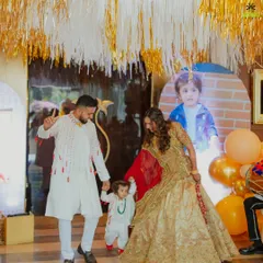 The birthday boy and his parents making a grand entrance. We love creating moments of joy and celebration for the whole family at our kids' parties.