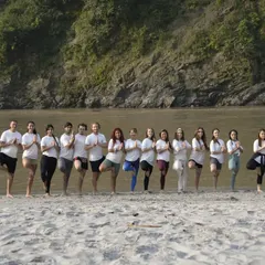 A shot of our yoga group practicing Vrikshasana (Tree Pose) together by the river in Rishikesh. I often organize these sessions to help us connect with nature and build a strong community, or 'bhaichara', through yoga.
