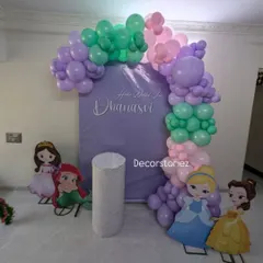 A sweet Disney princess theme for a baby girl's naming ceremony. We created a custom lavender backdrop with the baby's name, an organic balloon arch in pastel colors, and cutouts of beloved princesses.