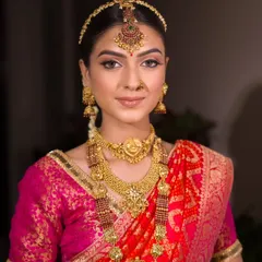 A portrait of timeless beauty. The makeup is perfectly balanced, with defined eyes, a warm complexion, and a natural lip that allows the stunning gold jewellery to take centre stage.