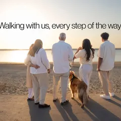 A powerful silhouette of a multi-generational family walking with their dog against the sunset. A timeless image of togetherness and shared journeys.