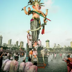 Devotees gather in the water at Girgaon Chowpatty for the visarjan (immersion) of the Mumbaicha Raja idol. This image captures the energy and devotion of the crowd as they bid farewell.