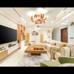 I designed this living room in a Jaipur apartment to be a harmonious blend of form, function, and comfort. The space features an L-shaped sofa, a statement chandelier, and custom wooden cabinetry with rattan details, all unified by a warm, earthy color palette.