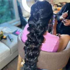 The foundation of a beautiful bridal braid. This shows the voluminous, wavy texture created before adding flowers and accessories for a Varapooja look.