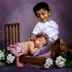 The other side of siblings, a moment of pure sweetness. After the playful shot, big brother gently checked on his sleeping baby sister. It's these unscripted moments that are just the best.