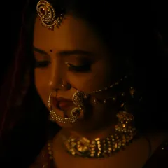 A candid moment captured under warm lighting. You can see how the makeup creates a soft glow on the skin, ensuring you look perfect from every angle, even in low light.
