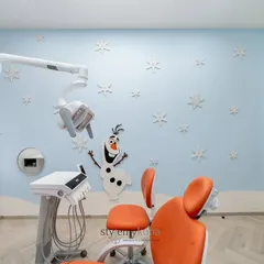 To make a pediatric dental clinic feel less intimidating, I brought the magic of Disney's 'Frozen' to life. This treatment room features a cheerful Olaf, snowflake wall details, and a calming blue palette, creating a friendly and stress-free environment for young patients.