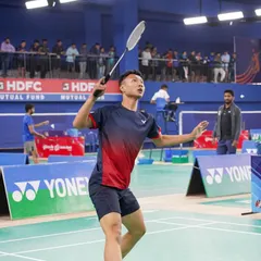 A player serves during the Yonex Sunrise All India Senior National Ranking Tournament. We ensure a professional atmosphere with clear court branding, official umpires, and an engaged audience.