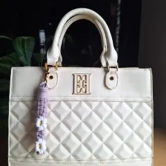 The daisy bag charm in a soft lavender color. These little floral accessories are one of our most popular items for gifting or as a small treat for yourself.