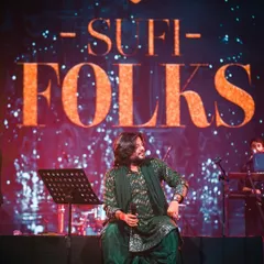A candid moment on stage, seated before the performance begins. This captures the calm before I pour all my energy into the music.