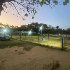Another view of our well-lit and securely fenced park at dusk. We ensure the environment is safe for play no matter the time of day.