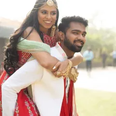 A fun piggyback ride during the Mehendi celebrations. It's these lighthearted, energetic moments that show a couple's true personality.