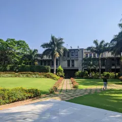 A case study of the IIM Bangalore campus, where manicured lawns and formal pathways contrast with the brutalist architecture, showcasing a masterclass in institutional landscape design.