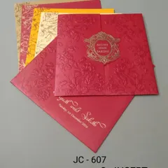 This bright red gate-fold invitation has an embossed texture and an ornate gold emblem. The set includes colorful inserts in yellow and cream for a festive look.