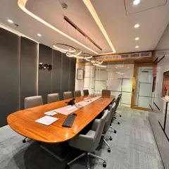 A view of the boardroom showing the integration of glass walls, which allows for a visual connection to the rest of the office while maintaining privacy. The design balances openness with the need for a focused meeting environment.